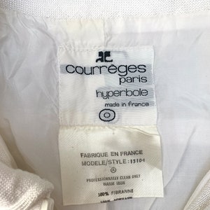 May include: White label with black text reading "Courreges Paris hyperbole made in France" and "Fabrique en France Modele/Style: 15104 Professionally clean only Warm iron 100% FIBRANNE".