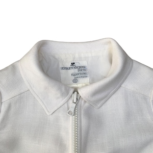 May include: White linen jacket with a zipper closure and a label that reads "Courr&egrave;ges Paris Hyperbole made in France".
