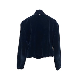 May include: A black velvet blazer with long sleeves and a button closure.