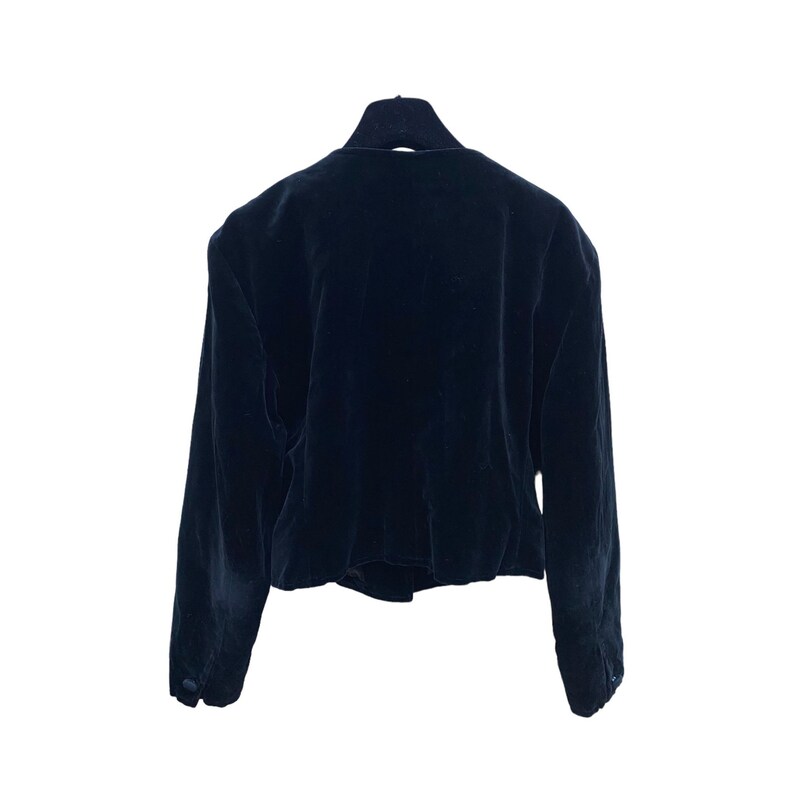 May include: A black velvet blazer with long sleeves and a button closure.