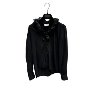May include: A black long-sleeved blouse with a large ruffled collar and a bow tie. The blouse has a button-up front and long sleeves.