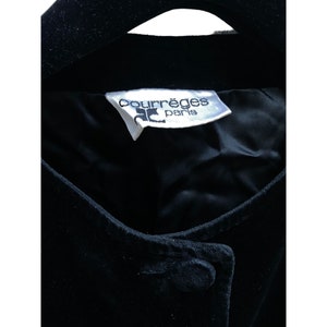 May include: A black velvet jacket with a white label that reads "Courr&egrave;ges Paris".