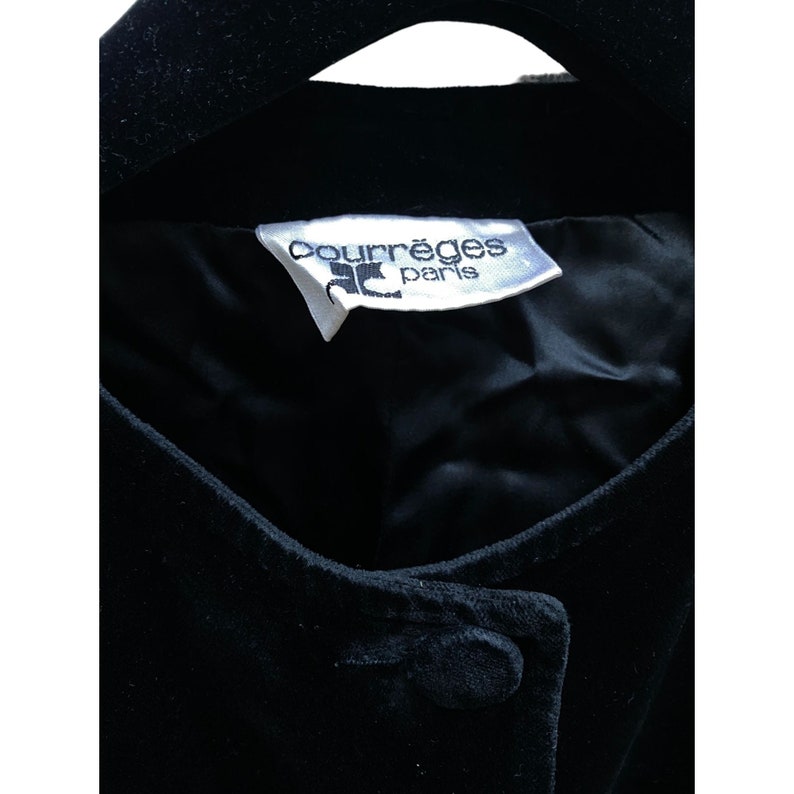 May include: A black velvet jacket with a white label that reads "Courr&egrave;ges Paris".