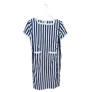 May include: A white and blue striped dress with short sleeves and a button closure on the side. The dress has two pockets on the front.