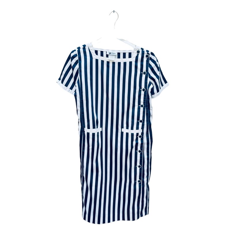 May include: A white and blue striped dress with short sleeves and a button closure on the side. The dress has two pockets on the front.