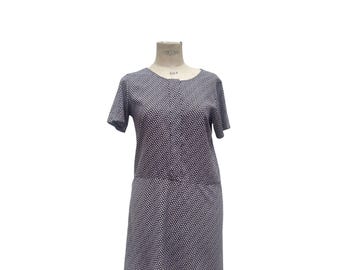 May include: A short-sleeved, navy blue and white patterned dress with a round neckline. The dress has a gathered waist and a slightly flared skirt.