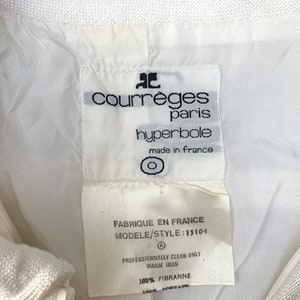 May include: White label with black text reading "ac courreges paris hyperbole made in france" and a circle symbol. Below is a white label with black text reading "FABRIQUE EN FRANCE MODELE/STYLE: 15104 A PROFESSIONNALLY CLEAN ONLY WARM IRON 100% FIBRANNE".
