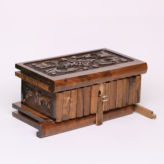 746 favorites don't lie — this hand-carved walnut custom secret-lock puzzle box with a hidden key is a masterclass in functional artisan craft, and the personalization option pushes it into perfect-gift territory.