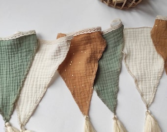 Sage green, camel, and ecru bunting for a baby's or child's room, made of cotton gauze in a retro vintage boho style.