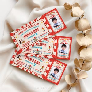 May include: Three rectangular circus-themed birthday invitation tickets with red and cream borders. Each features a photo of a child, the text "COME ONE, COME ALL!", "JOHANES IS TURNING 3", "ADMIT ONE", and event details including date, time, and location.