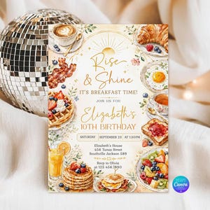 May include: A rectangular birthday invitation card featuring watercolour illustrations of breakfast foods including waffles, pancakes, bacon, eggs, and coffee. The text reads Rise & Shine It's Breakfast Time! Join us for Elizabeth's 10th Birthday, Saturday September 23 at 1:30PM.
