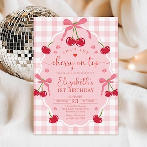 May include: A rectangular invitation card with a pink and white gingham background featuring red cherry illustrations, pink bows, and a decorative white frame. The text reads: She's the cherry on top, Elizabeth's 1st Birthday, September 23 at 1:30pm.
