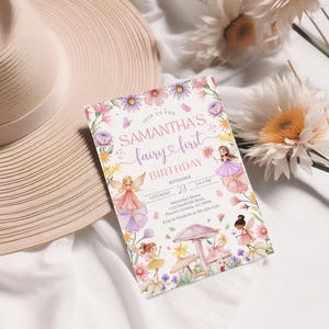 May include: A fairy-themed birthday invitation with the text "Samantha's Fairy First Birthday." The invitation features illustrations of fairies, flowers, and a mushroom. The invitation is surrounded by flowers and a sun hat.