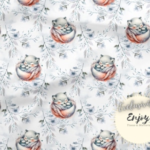 May include: A seamless pattern featuring watercolor illustrations of foxes curled up in nests, surrounded by delicate blue and gray floral branches on a white background. The text "Exclusive Enjoy Tissus & Mercerie" is in the lower right corner.