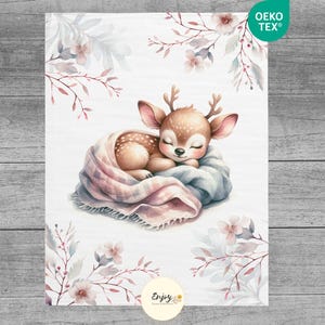 May include: A watercolor illustration of a fawn sleeping in a pink and blue blanket with white flowers and leaves in the background. The text "Enjoy" is at the bottom of the image.
