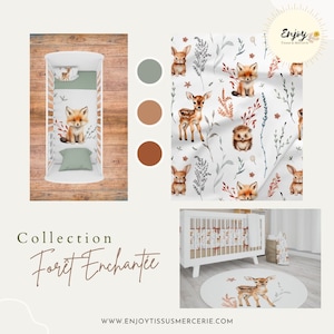 May include: A white cot with a white and brown patterned bedding set. The bedding features a woodland theme with foxes, deer and hedgehogs. The cot is on a wooden floor with a round rug featuring a deer. The text "Collection For&ecirc;t Enchant&eacute;e" is visible below the cot. The text "Enjoy Tissus & Mercerie" is visible in the top right corner of the image.