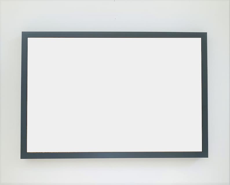 May include: A blank, white rectangular sign with a dark gray frame.