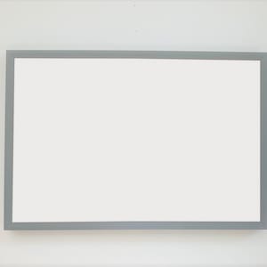 May include: A white rectangular whiteboard with a silver frame.