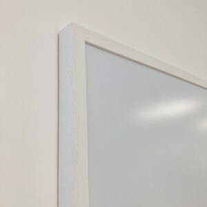 May include: A white framed whiteboard with a smooth surface.