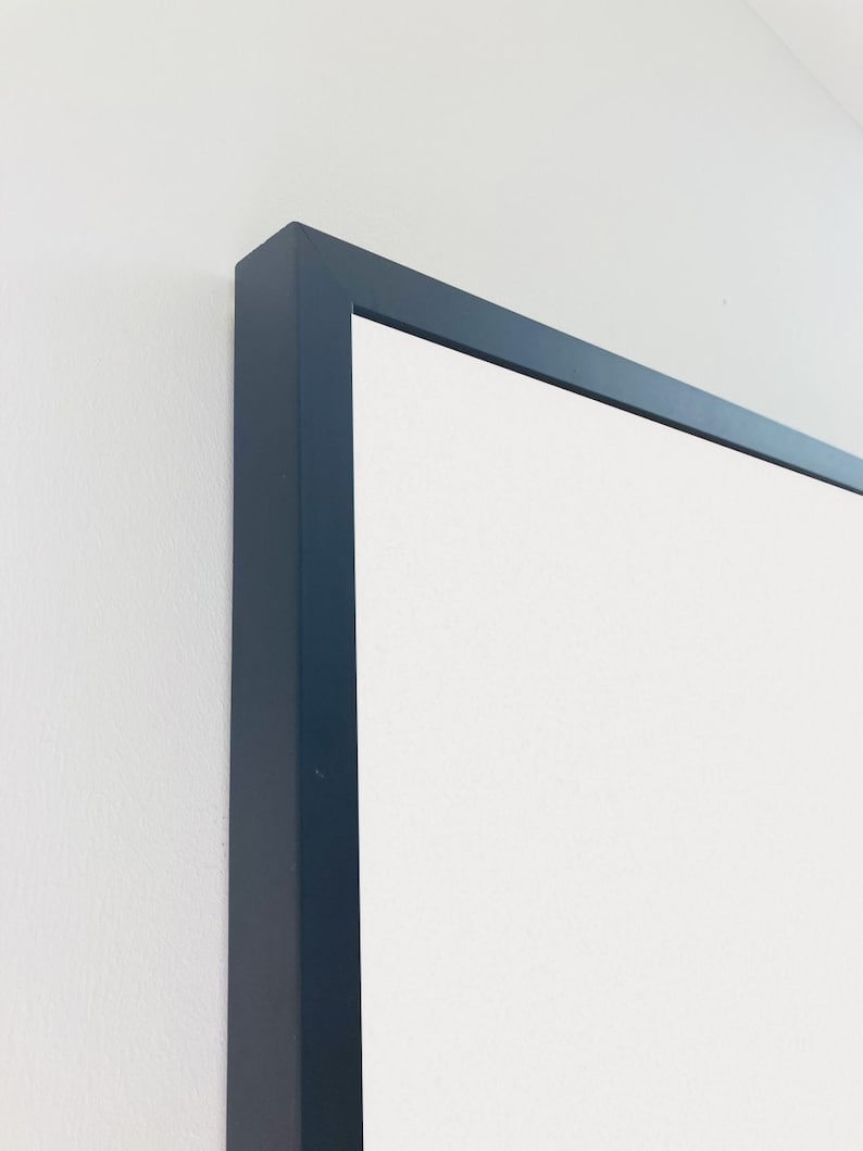 May include: Close-up of the top corner of a black picture frame.