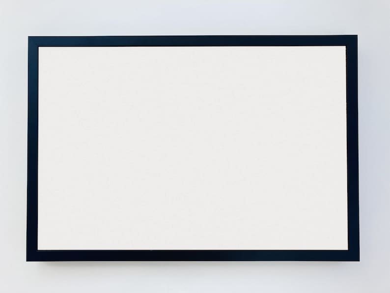 May include: A black picture frame with a white mat and a white background.