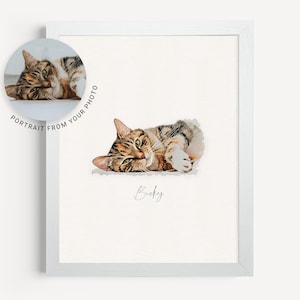 May include: A watercolor painting of a tabby cat lying on its side with its paws curled up. The cat has green eyes and a brown and black striped coat. The painting is on a white background with the name "Bucky" written below the cat.