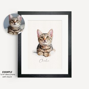 May include: A watercolor painting of a tabby cat named Charlie in a black frame with a white mat. The cat is looking up with its mouth closed. The painting is 11x14 inches.