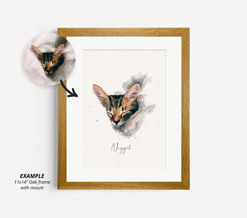 May include: A watercolor painting of a sleeping cat named "Nugget" in a brown wooden frame. The cat is brown and black with white markings. The painting is on a white background with a gray watercolor wash.