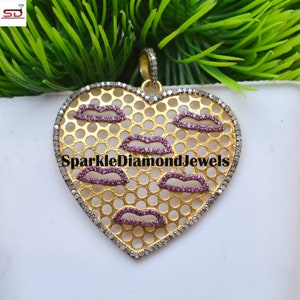 May include: A gold heart-shaped pendant with a delicate diamond border. The pendant features a cutout design of lips outlined with pink gemstones. The pendant is labeled "SparkleDiamondJewels".