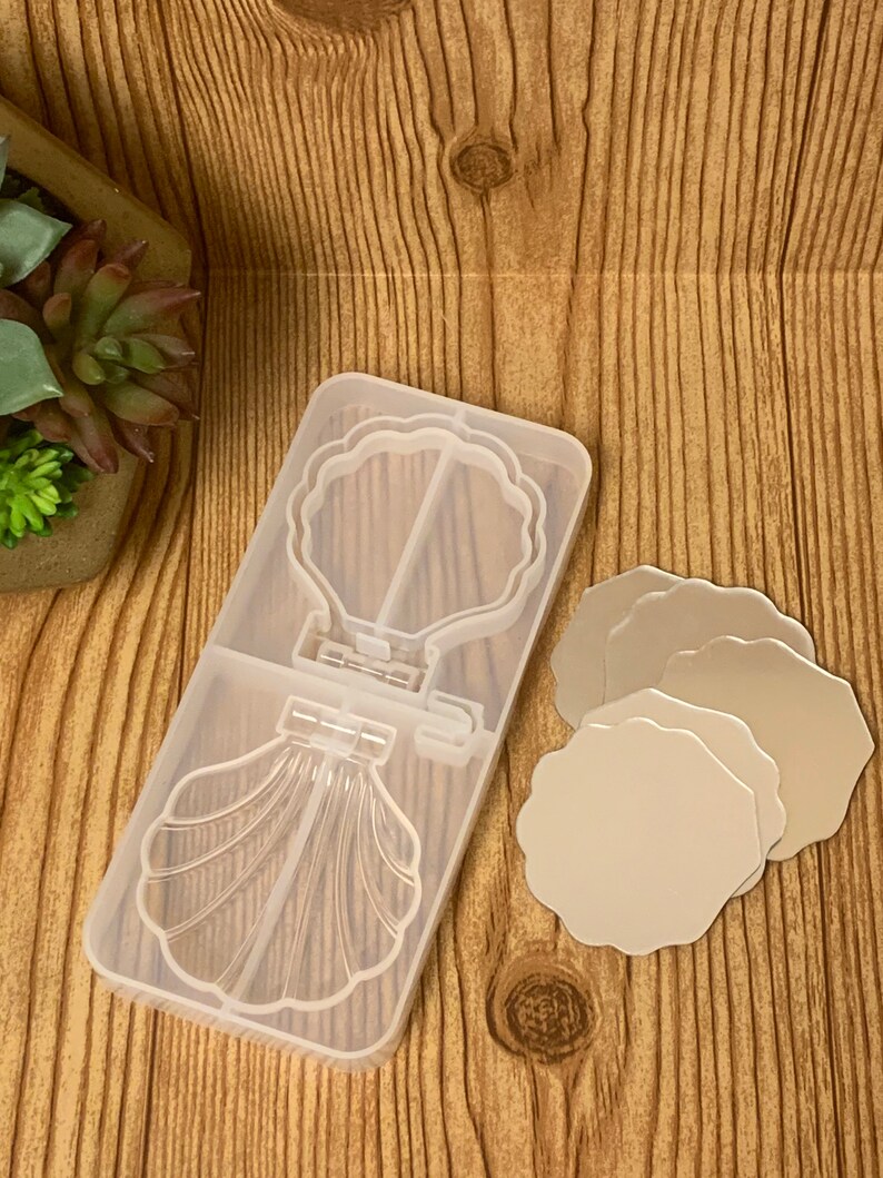 May include: Clear silicone mold for making resin crafts. The mold features a seashell design with a mirror inside. Three separate round mirror molds are also included.