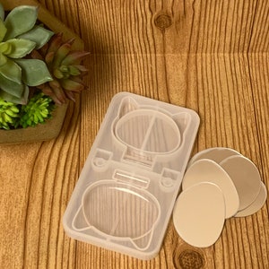 May include: A clear silicone mold for making resin crafts. The mold is shaped like a cat with two round cavities for making earrings or charms. The mold comes with four clear round silicone molds for making additional charms.