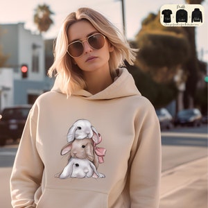 a woman wearing a hoodie with a picture of a bunny on it