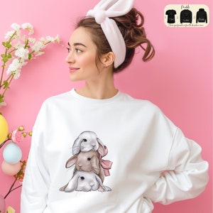 a woman wearing a sweatshirt with a picture of two elephants on it