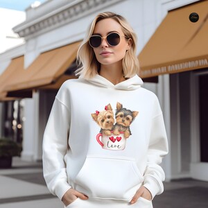 a woman wearing a white sweatshirt with two dogs on it