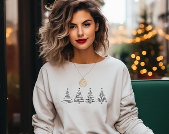 May include: A white sweatshirt with a black outline of four Christmas trees. The trees are stylized and have a simple design. The sweatshirt has a gold necklace with a round pendant.