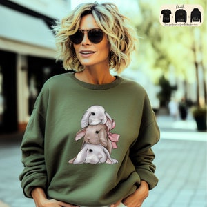 a woman wearing a sweatshirt with a picture of a dog on it
