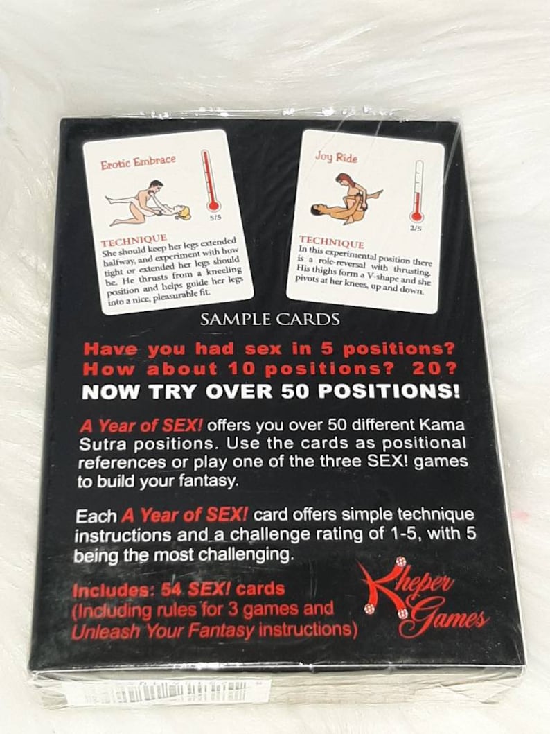 May include: A Year of SEX! card game in a sealed package. The black box features sample cards with illustrations and instructions for various positions. The text on the box reads "NOW TRY OVER 50 POSITIONS!" and includes 54 cards.