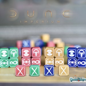 May include: A set of wooden dice with different symbols and colours, including green, blue, red, and brown. The dice are for the board game Dune: Imperium.