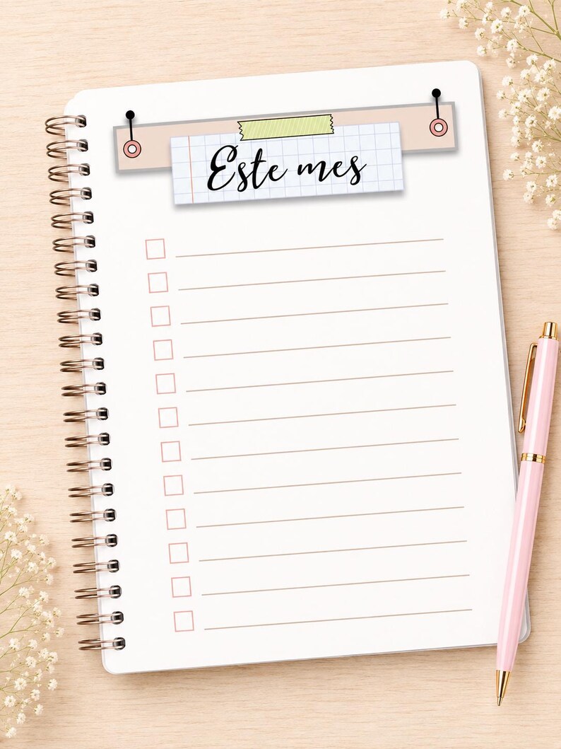 May include: A spiral-bound notebook with white pages featuring horizontal lines and a checklist column. At the top, a rectangular graphic displays the text "Este mes" on a grid-patterned paper strip, secured by a piece of light green tape.
