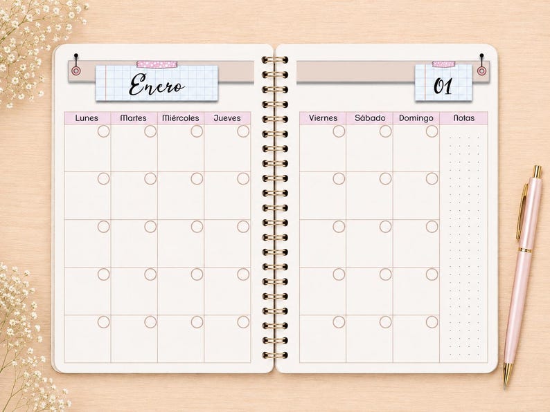 May include: A spiral-bound planner open to a monthly calendar spread. The left page is labeled Enero and the right page is labeled 01. The grid features columns for days of the week in Spanish, small circular icons in each box, and a notes section.