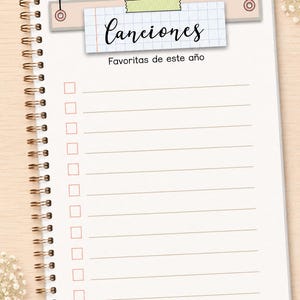 May include: A spiral-bound notebook page featuring a grid-patterned header with the text Canciones and the subtitle Favoritas de este a&ntilde;o. Below the header, there are ten horizontal lines with empty checkboxes for a list of favorite songs.