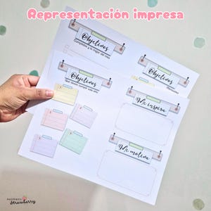 May include: A printed planner page featuring sections labeled Objetivos, Me inspira, and Me motiva. The layout includes pastel-colored index cards numbered one through six, decorative headers with pushpin graphics, and lined writing spaces.