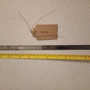 May include: A metal ruler measuring 12 inches with a tag labeled "P1185".