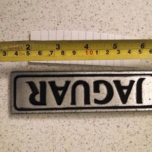 Jaguar name plate from XJ 40. Cleaned repainted in black and lacquered.