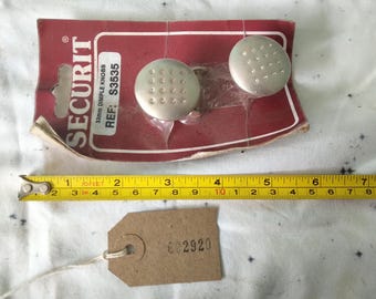 pair of new old stock cupboard door knobs in original packing. 002920