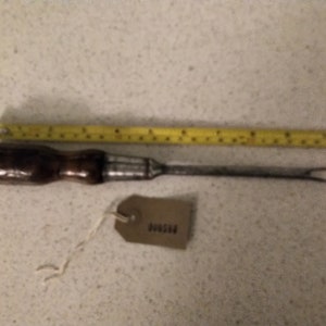Mdeium wooden handled Flat head screwdriver in good working condition.  A bit battered but still a good tool
