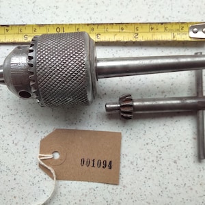 French chuck mounted on a taper and chuck key both in working condition although a little beaten up