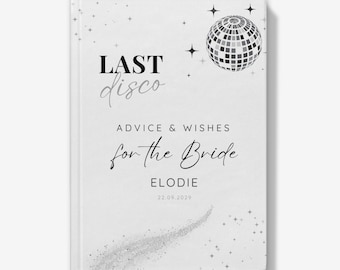 May include: A white book with a silver glitter design and a disco ball graphic. The text on the cover reads "Last disco Advice & Wishes for the Bride Elodie 22.09.2029".