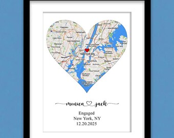 May include: A framed print featuring a heart-shaped map of New York City with a red heart icon over the city center. Below the map, the text reads monica heart jack, Engaged, New York, NY, and 12.20.2025. The print is inside a black frame with a white matte.