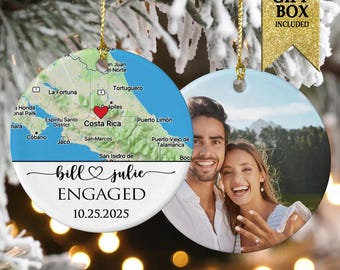 May include: Round ceramic Christmas ornament with a map of Costa Rica and the words "bill & julie ENGAGED 10.25.2025". The other side features a photo of a smiling couple. Includes a gold string for hanging.